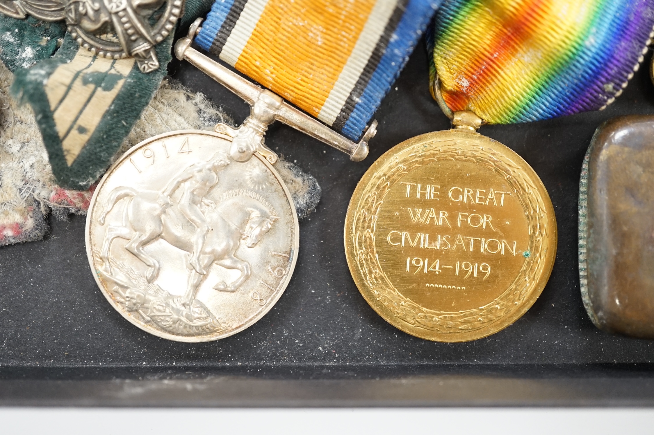 A collection of military cap badges and medals, including a First World War medal pair awarded to A.M. F.W. Wright, together with seventeen British and German cap badges including; the West Yorkshire Regiment, the Royal